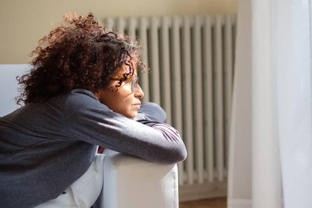 Woman feeling negative emotions lying on the sofa - Foto, Imagen