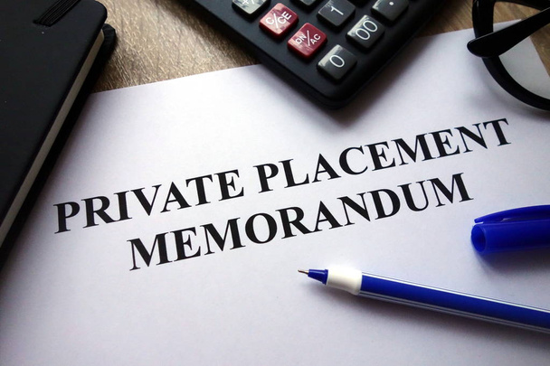 Private placement memorandum document, pen, glasses and calculator on desk - Photo, Image
