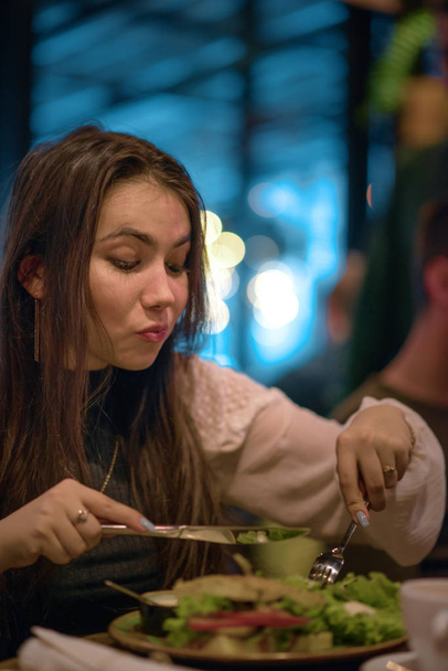 Young girl has lunch in a restaurant - Photo, Image
