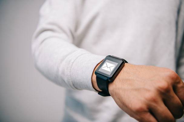 cropped view of man with smartwatch with email icon - Fotografie, Obrázek