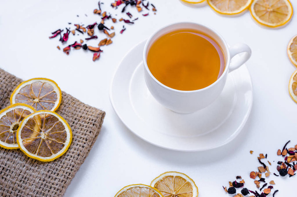 Orange herbal flavored christmas tea with cinnamon and cardamom honey white cup on a white wooden table  - Foto, immagini