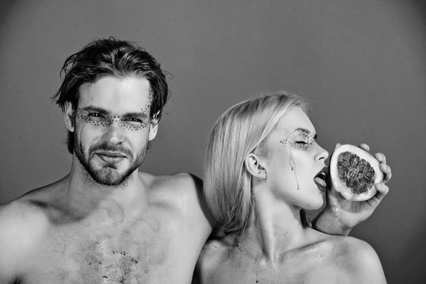 couple of woman and man with makeup hold grapefruit - Фото, изображение
