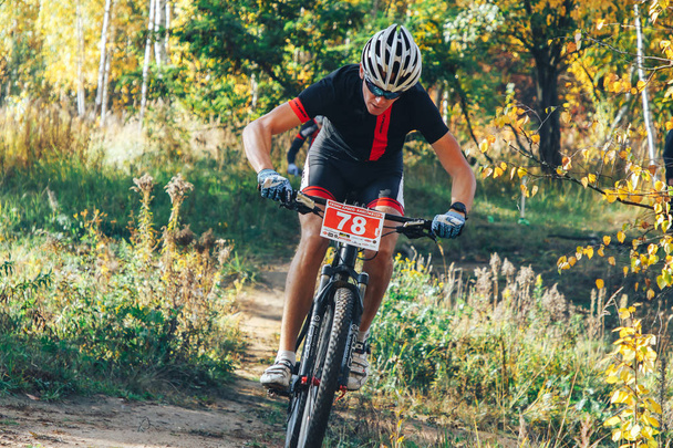 October 14, 2018, Minsk, Belarus: 2018 Olympic Cross Country Cup XCO in Medvezhino, man riding bicycle in park - Photo, image