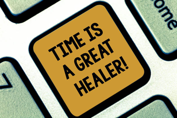 Text sign showing Time Is A Great Healer. Conceptual photo Emotional pain will grow less after a while Keyboard key Intention to create computer message pressing keypad idea. - Photo, Image