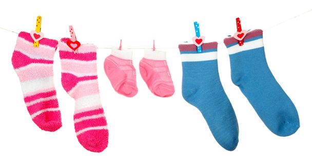 Colorful socks hanging on clothesline, isolated on white - Fotó, kép
