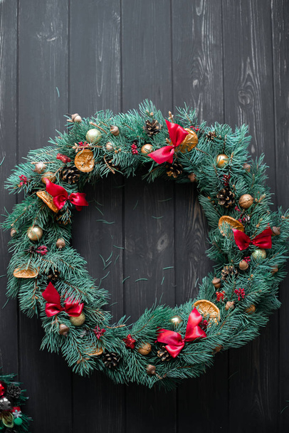 Natural Christmas wreath on black wooden background - Photo, Image