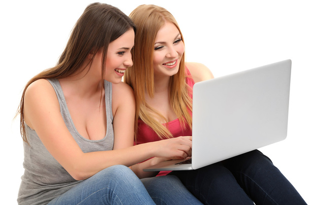 Two girl friends with with laptop isolated on white - Foto, Bild