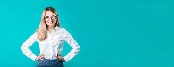 Blank for advertising. Portrait young caucasian woman worker teacher coach mentor in white shirt office style business lady leader advertising glasses eyesight blue isolated color background. - Фото, зображення