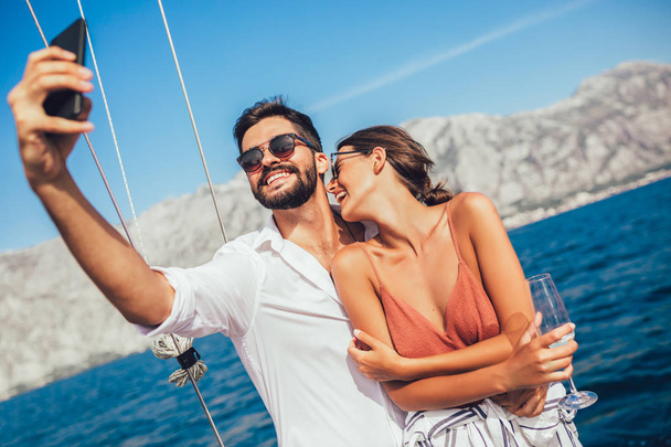 Couple in love on a sail boat in the summer. - Foto, imagen
