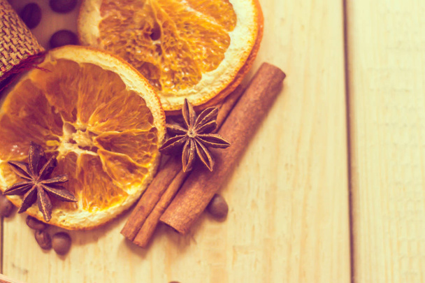 Dried orange and cinnamon on wooden background. - Photo, image