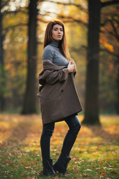 Photo of long-haired girl in autumn park in afternoon. - Foto, Imagem