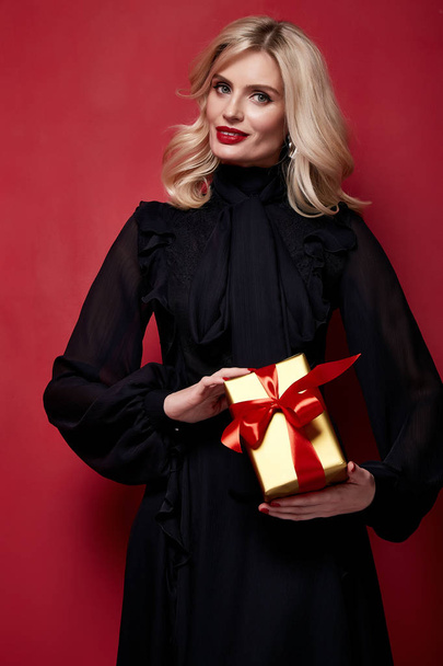 Beautiful young pretty woman bright evening make-up of shiny red lipstick on the lips blond curly hair festive mood knitted winter Christmas New Year and birthday St. Valentine's Day gift surprise. - Φωτογραφία, εικόνα