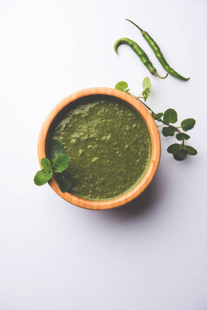 Healthy Green Mint Chutney Made with Coriander, pudina And Spices. isolated moody background. selective focus - Photo, Image