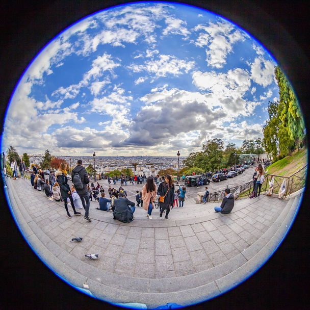 PARIS, FRANCE, on OCTOBER 26, 2018. The city panorama opening from the Montmartre hill. Tourists admire a view. Fish-eye view - Fotó, kép