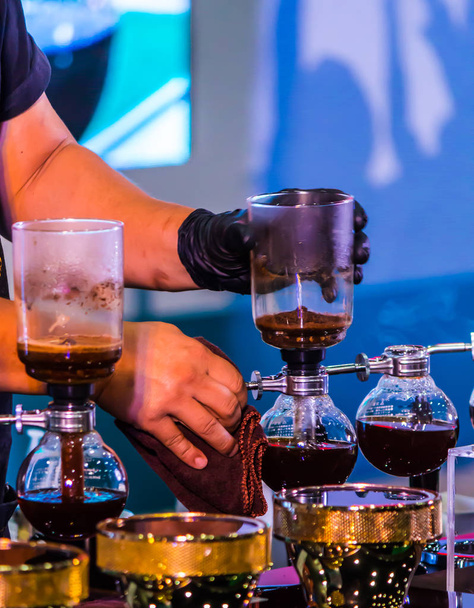 Syphon Coffee or Vacuum Coffee is full immersion tasteful, this picture show mix coffee beans into boiling water and stir 10 time. - Fotoğraf, Görsel