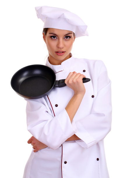 Portrait of young woman chef with flying pan isolated on white - Fotó, kép