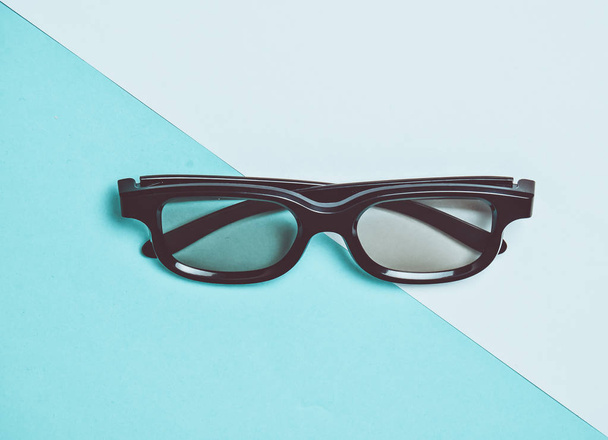 3D glasses on a colored pastel background. Minimalist trend, top view, flat lay. - Photo, Image