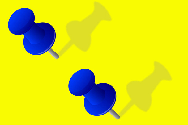 Close - up dvěma modrými kolíky na žlutém podkladu - Fotografie, Obrázek