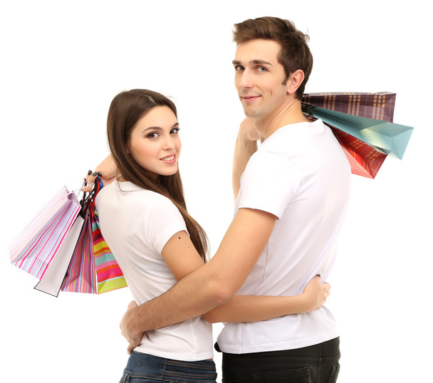 Young couple shopping and holding many shopping bags isolated on white - Photo, Image