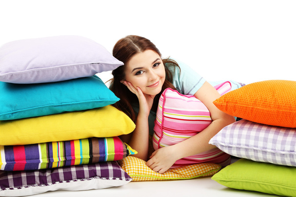 Beautiful young girl with pillows isolated on whit - Photo, Image