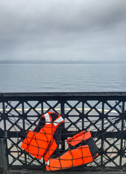 Two life vests stowed in safety netting on car ferry. - Photo, Image