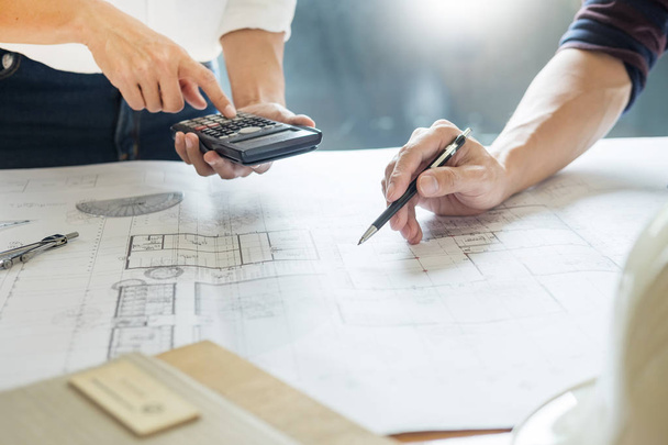 professional architects working on blueprint discussing construction plans, engineer building, business co-working teamwork concept - Фото, изображение