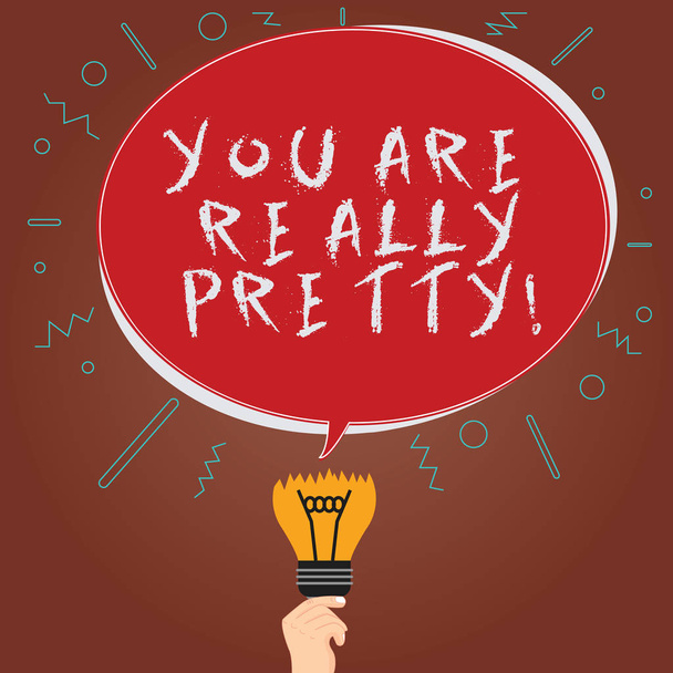 Conceptual hand writing showing You Are Really Pretty. Business photo showcasing Flirting beauty appreciation roanalysistic feelings Oval Speech Bubble Above a Broken Bulb with Failed Idea icon. - Photo, Image