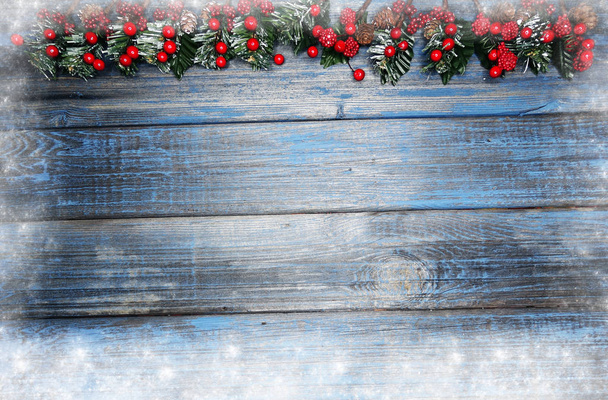 christmas background fir tree branch with cones and snow on wooden blue board - Photo, Image