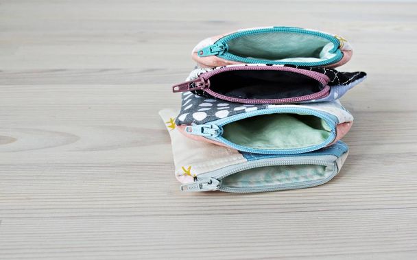 Handmade fabric mini pouches on the wooden table - Foto, Bild
