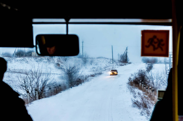 Autobus se pohybuje po zasněžené silnici. Komplikovaných počasí v zimě - Fotografie, Obrázek