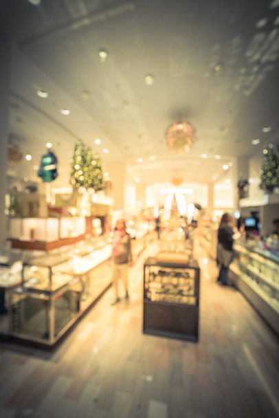 Vintage tone blurred motion customer shopping at upscale clothing store in downtown Dallas, Texas, USA during holiday season. Defocused expensive shoes, handbags, jewelry, accessories, beauty products - Photo, Image