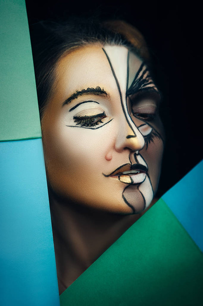 A model is emotionally posing with creative makeup - Photo, Image