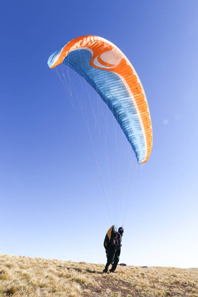 Ik fotograferen mensen die met paragliding bezighouden zich, ze leren om te vliegen paragliders, ze willen wat ze, krijgen extreme emoties, een heleboel emoties, paragliding is zeer gevaarlijk. Hoog in de bergen is erg mooi - Foto, afbeelding