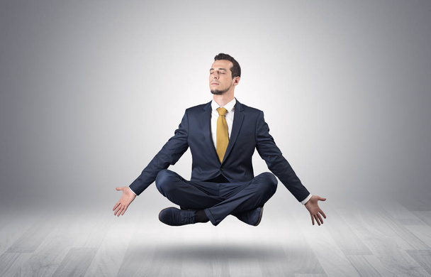Businessman meditates in an empty space concept - Zdjęcie, obraz