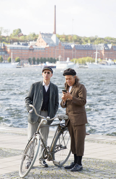 STOCKHOLM - SEPT 22, 2018: GTwo men wearing old fashioned tweed clothes preparing for the Bike in Tweed event in Tweed event September 22, 2018 in Stockholm, Sweden - Zdjęcie, obraz