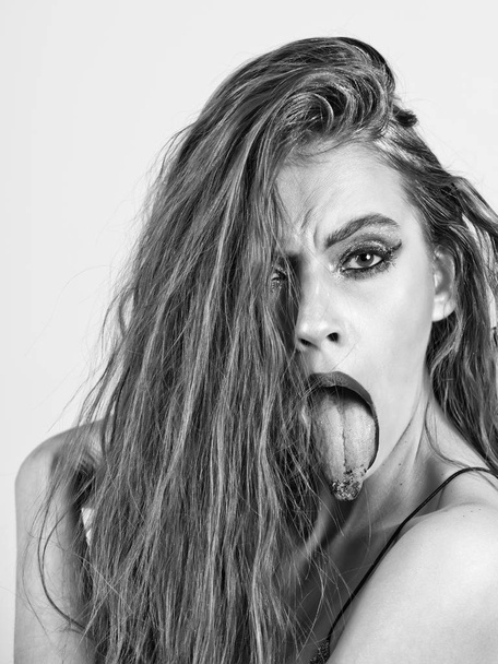 beautiful girl with bright make up, fashionable hairstyle showing tongues - Fotografie, Obrázek