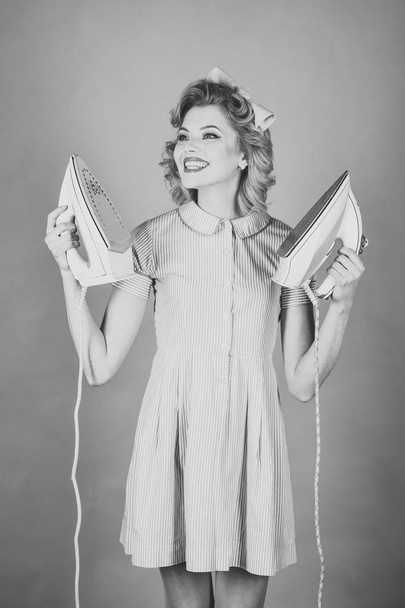 Pinup woman hold iron, retro style, maid. - Foto, imagen