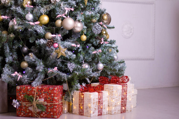 holidays, winter and celebration concept - New Year composition with Christmas tree and presents gifts boxes - Foto, Imagen