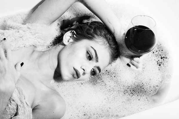 Closeup of woman with glass in bath - Foto, imagen