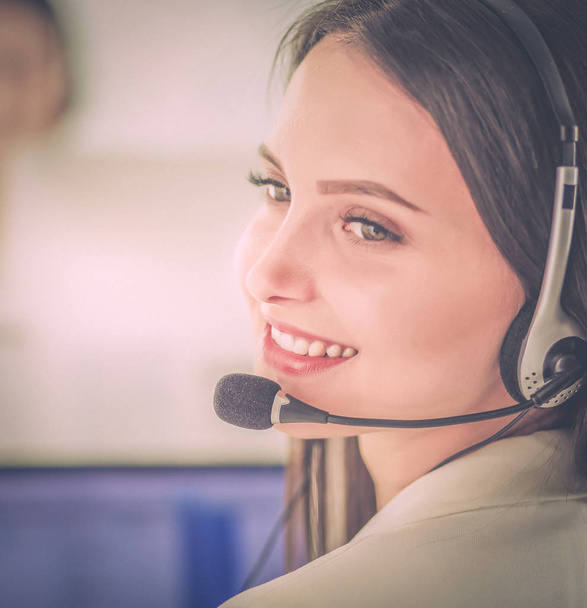 Smiling businesswoman or helpline operator with headset and computer at office - Fotografie, Obrázek