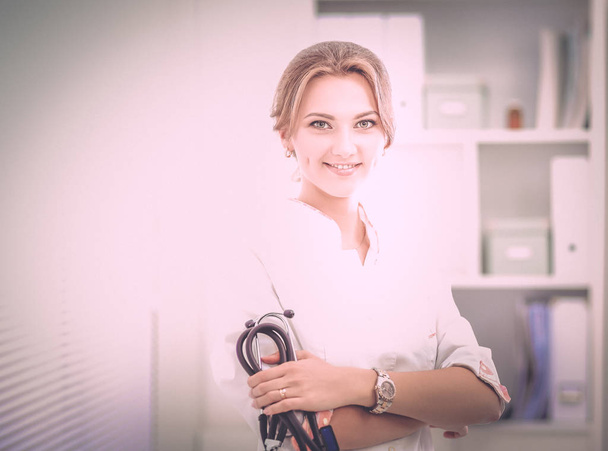 Young woman doctor standing at hospital with medical stethoscope - Fotografie, Obrázek