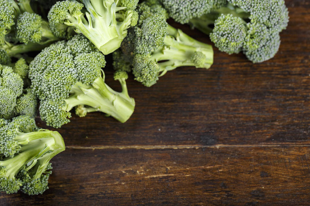 Fresh broccoli cabbage on wooden background. clearly visible texture of inflorescences. space for tex - Photo, image