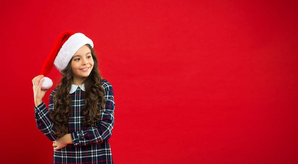Happy winter holidays. Small girl. Present for Xmas. Childhood. Christmas shopping. Little girl child in santa red hat. New year party. Santa claus kid. Magic moment. copy space. - Foto, Imagem