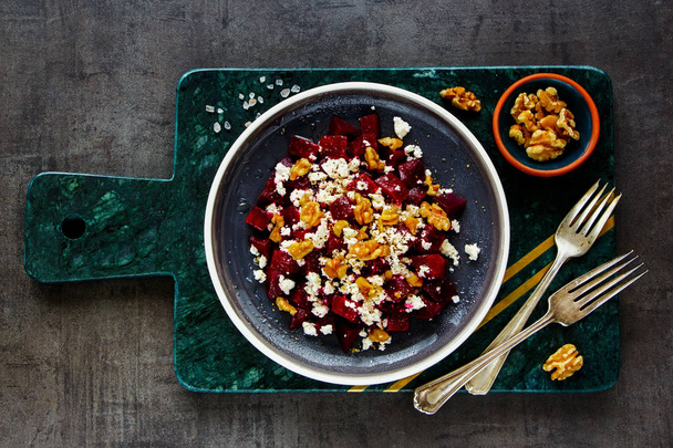 Flat lay of fresh roasted beetroot salad with walnut and feta cheese  - Foto, imagen