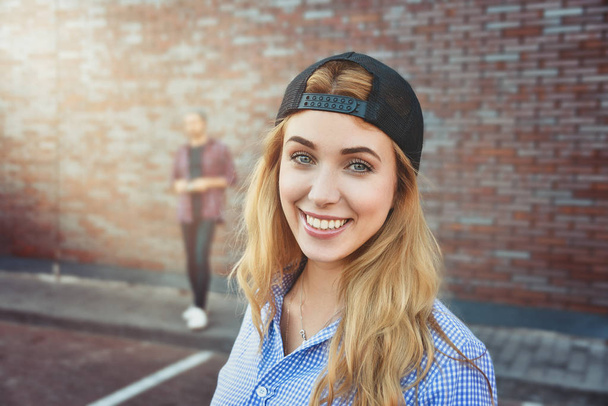 Pleased Caucasian teenage girl wears black cap and shirt, going to have stroll with friends, poses against white background. Youngster woman dressed in fashionable clothes. - Φωτογραφία, εικόνα