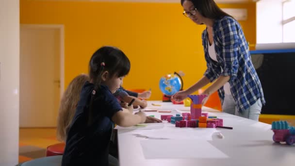 Multicultural children drawing in kindergarten - Footage, Video