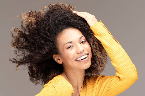 Happy african american woman smiling. Beautiful female half-length portrait. Young emotional afro woman. The human emotions, facial expression concept. - Zdjęcie, obraz