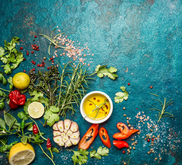 Fresh herbs and spices on blue turquoise background. - garlic, laurel, lime, rosemary, parsley pepper - Foto, imagen