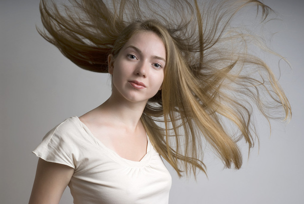 Young girl with flying fair hair - Foto, Imagen