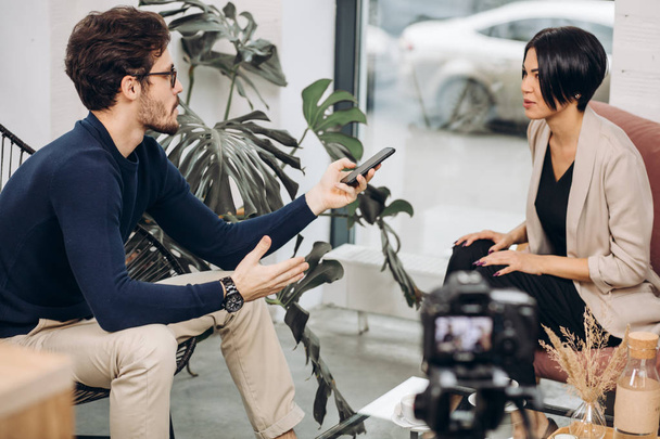 awesome man and attractive fashion girl is having an interview - Φωτογραφία, εικόνα